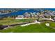 Aerial view of coastal homes near a beautiful golf course offering stunning scenery at 621 Ivanhoe Ln, Holmes Beach, FL 34217