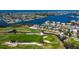 Gorgeous overhead view of waterfront homes on the golf course with stunning water views on a sunny day at 621 Ivanhoe Ln, Holmes Beach, FL 34217