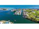 Expansive aerial showcasing waterfront property, community, and golf course, ideal for coastal living at 621 Ivanhoe Ln, Holmes Beach, FL 34217
