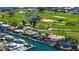 Aerial shot of the waterfront homes, lush golf course, and beautiful canal, creating serene coastal living at 621 Ivanhoe Ln, Holmes Beach, FL 34217