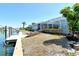 Inviting backyard with canal access, featuring a boat lift and space for waterfront enjoyment at 621 Ivanhoe Ln, Holmes Beach, FL 34217
