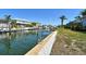 View of canal-front backyard with boat lift, perfect for boating and enjoying waterfront lifestyle at 621 Ivanhoe Ln, Holmes Beach, FL 34217