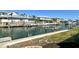 Backyard view of a waterfront canal with boat lift, enhancing the waterfront living experience at 621 Ivanhoe Ln, Holmes Beach, FL 34217