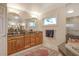 Bathroom features a large mirror, double sinks, granite countertop and soaking tub at 621 Ivanhoe Ln, Holmes Beach, FL 34217