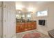 Bathroom featuring double sinks, granite countertop, large mirror and a soaking tub at 621 Ivanhoe Ln, Holmes Beach, FL 34217