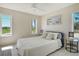 Sunlit bedroom with serene views of the golf course and tropical landscaping at 621 Ivanhoe Ln, Holmes Beach, FL 34217