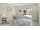 Light-filled bedroom with sliding glass doors leading to a screened lanai and pool at 621 Ivanhoe Ln, Holmes Beach, FL 34217