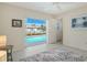 Bedroom with an outdoor pool view and sliding glass door to a screened-in lanai at 621 Ivanhoe Ln, Holmes Beach, FL 34217