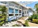 Inviting home featuring a welcoming entrance with a small pond and lush landscaping at 621 Ivanhoe Ln, Holmes Beach, FL 34217