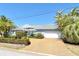 Beautiful home featuring an attached garage, meticulous landscaping, and a neutral color scheme at 621 Ivanhoe Ln, Holmes Beach, FL 34217