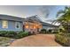 Charming home with a pergola over the entrance, highlighted by a mix of shrubbery and a circular driveway at 621 Ivanhoe Ln, Holmes Beach, FL 34217