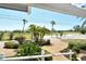 Landscaped front yard featuring lush greenery and a view of the golf course at 621 Ivanhoe Ln, Holmes Beach, FL 34217