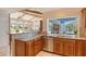 Kitchen features granite counters, stainless appliances, and views to the living and pool areas at 621 Ivanhoe Ln, Holmes Beach, FL 34217