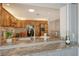 View from the kitchen island of wood cabinetry, granite countertops, and stainless-steel appliances at 621 Ivanhoe Ln, Holmes Beach, FL 34217