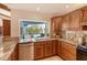 Kitchen with granite countertops and stainless steel appliances and views of the pool area at 621 Ivanhoe Ln, Holmes Beach, FL 34217