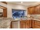 Kitchen featuring stainless steel appliances and granite countertops with a view of the pool at 621 Ivanhoe Ln, Holmes Beach, FL 34217