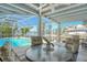 Covered lanai seating area with a pool and canal view at 621 Ivanhoe Ln, Holmes Beach, FL 34217