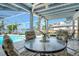 Lanai featuring canal and pool views, enhanced by light, airy design with covered seating at 621 Ivanhoe Ln, Holmes Beach, FL 34217