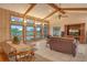 Inviting living area featuring beamed ceilings, comfortable seating, and golf course views at 621 Ivanhoe Ln, Holmes Beach, FL 34217
