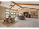 Bright and airy living room features wood paneling and views of the golf course at 621 Ivanhoe Ln, Holmes Beach, FL 34217