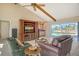 Comfortable living room with vaulted ceilings, ceiling fan, and a view of the pool outside the sliding glass doors at 621 Ivanhoe Ln, Holmes Beach, FL 34217