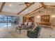 Open living space with vaulted ceilings, tile floors, and an outdoor patio view at 621 Ivanhoe Ln, Holmes Beach, FL 34217