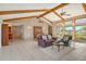 Comfortable living room with vaulted ceilings and natural light streaming in from the windows at 621 Ivanhoe Ln, Holmes Beach, FL 34217