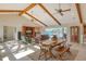 Spacious living room with beamed ceilings and sliding glass doors to the water at 621 Ivanhoe Ln, Holmes Beach, FL 34217