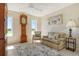 Cozy living room with decorative rug, grandfather clock, and views of outdoors at 621 Ivanhoe Ln, Holmes Beach, FL 34217