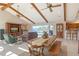Open-concept living and dining area with high ceilings and large sliding glass doors leading to the outdoor pool at 621 Ivanhoe Ln, Holmes Beach, FL 34217