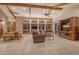 Open-concept living and dining area with custom woodwork, beamed ceilings and neutral tile flooring at 621 Ivanhoe Ln, Holmes Beach, FL 34217