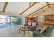 Open-concept living room with vaulted ceilings, ceiling fans, and view of the outdoor patio and canal at 621 Ivanhoe Ln, Holmes Beach, FL 34217