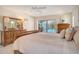 Calm primary bedroom with access to the pool and screened in lanai at 621 Ivanhoe Ln, Holmes Beach, FL 34217