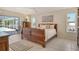 Bright main bedroom with king bed and sliding glass doors to the pool area at 621 Ivanhoe Ln, Holmes Beach, FL 34217