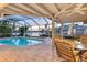 Screened lanai overlooking the pool and channel at 621 Ivanhoe Ln, Holmes Beach, FL 34217