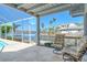 Relaxing screened patio with comfortable seating and view of canal, blending indoor comfort with outdoor scenery at 621 Ivanhoe Ln, Holmes Beach, FL 34217