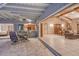 Inviting patio with dining set that opens to a living area and kitchen through sliding glass doors at 621 Ivanhoe Ln, Holmes Beach, FL 34217