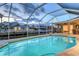 Screened-in pool with waterfront views and comfortable seating, perfect for relaxation and entertainment in the beautiful outdoors at 621 Ivanhoe Ln, Holmes Beach, FL 34217