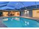 Screened pool reflecting the home's architecture and interior living spaces, creating a seamless transition between indoors and outdoors at 621 Ivanhoe Ln, Holmes Beach, FL 34217