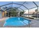 Beautiful caged pool overlooks a wide canal and lush tropical landscaping at 621 Ivanhoe Ln, Holmes Beach, FL 34217