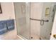 Accessible shower with glass door, grab bar, and tiled walls in a bright, clean bathroom at 621 Ivanhoe Ln, Holmes Beach, FL 34217