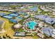 An aerial view featuring a community pool, tennis courts, clubhouse, and manicured landscaping at 6248 Fish Eagle Ct, Nokomis, FL 34275