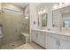 Contemporary bathroom with a spacious glass shower, double vanity, and bright lighting at 6248 Fish Eagle Ct, Nokomis, FL 34275