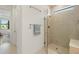 Modern bathroom featuring glass shower, neutral tiling, and sleek fixtures at 6248 Fish Eagle Ct, Nokomis, FL 34275