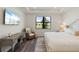 Comfortable bedroom featuring a desk, chair, and view overlooking lush greenery at 6248 Fish Eagle Ct, Nokomis, FL 34275