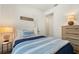 Charming bedroom features nautical decor, a side table with lamp, and a wood dresser at 6248 Fish Eagle Ct, Nokomis, FL 34275