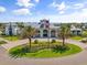 Stunning clubhouse exterior featuring an American flag, elegant architecture, and lush landscaping at 6248 Fish Eagle Ct, Nokomis, FL 34275