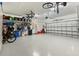 Spacious two-car garage with speckled floor and organized storage racks for bikes and accessories at 6248 Fish Eagle Ct, Nokomis, FL 34275