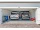 Two-car garage equipped with epoxy flooring and two automobiles at 6248 Fish Eagle Ct, Nokomis, FL 34275