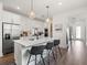 Spacious kitchen featuring a large island with bar seating, stainless appliances, and stylish pendant lights at 6248 Fish Eagle Ct, Nokomis, FL 34275